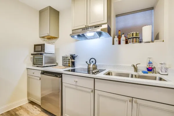 a kitchen with cabinets a sink and appliances