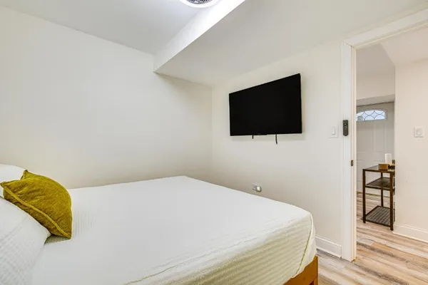 a bedroom with a bed and a flat screen tv