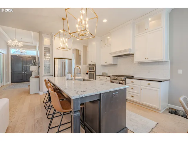 a kitchen with a table chairs and cabinets