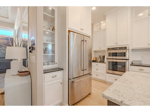 a kitchen with stainless steel appliances a refrigerator and a stove
