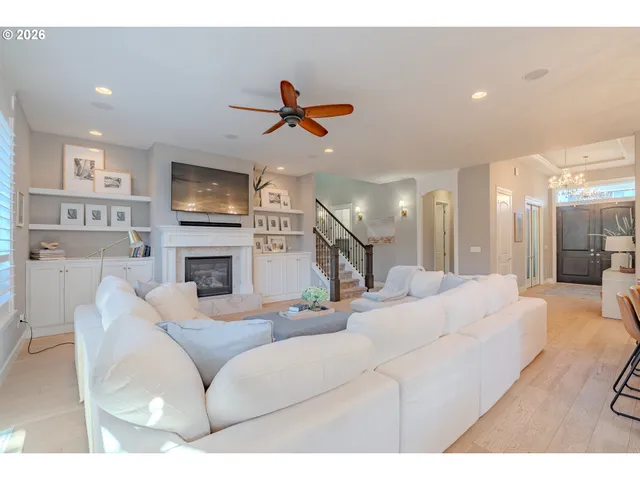a living room with fireplace furniture and a flat screen tv