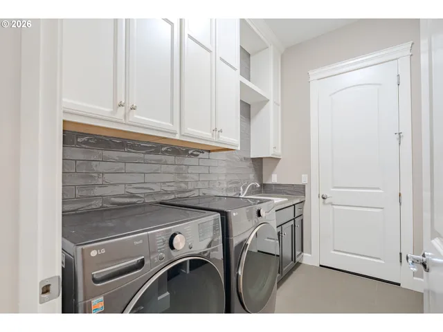 a kitchen with a stove and white cabinets