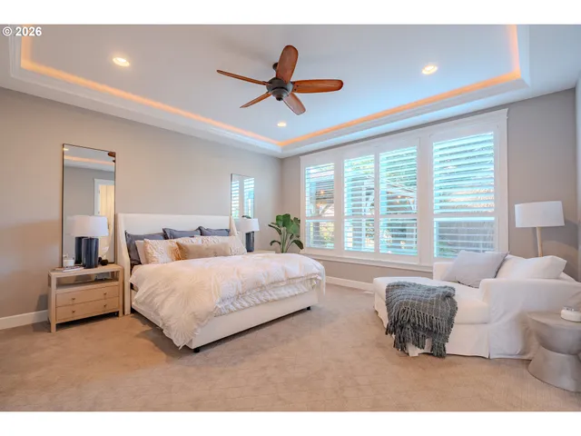 a spacious bedroom with a bed and a large window