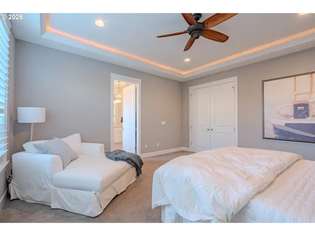 a bedroom with a bed and a chandelier