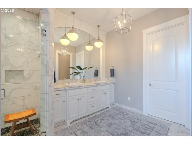 a bathroom with a sink vanity and a mirror