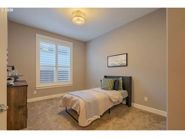 a bedroom with a bed and a desk