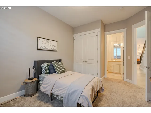 a bedroom with a bed and a painting