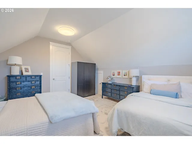 a bedroom with a bed and a television