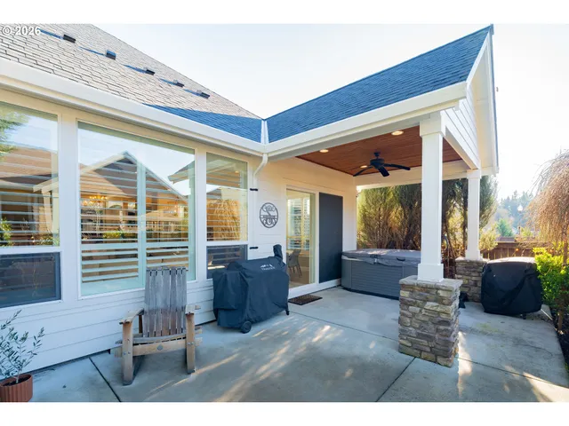 a living room with furniture and large windows