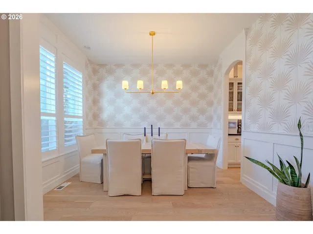 a view of a dining room with furniture and chandelier