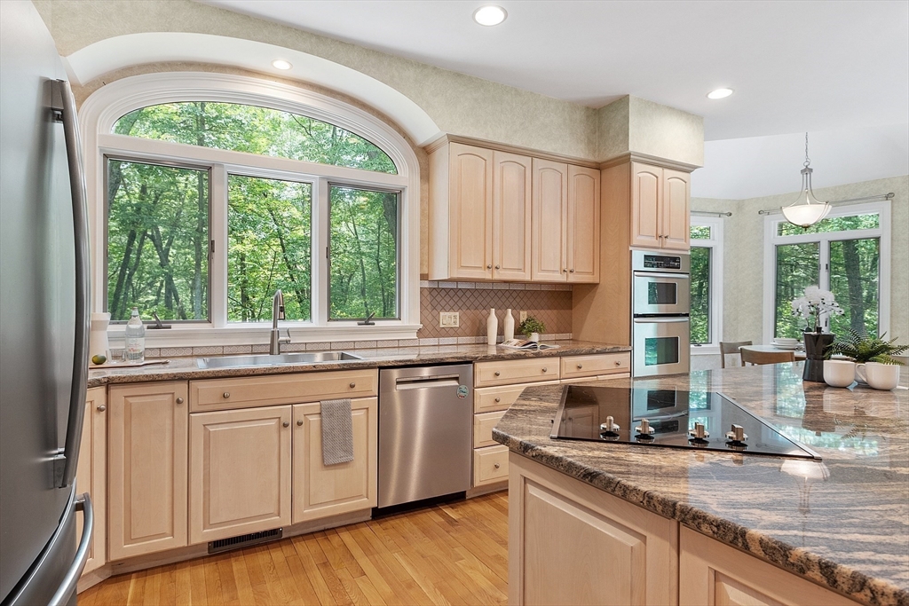 151 Pope Road Acton, MA 01720 - Photo 13 of 34 a kitchen with stainless steel appliances granite countertop a stove a sink and white cabinets