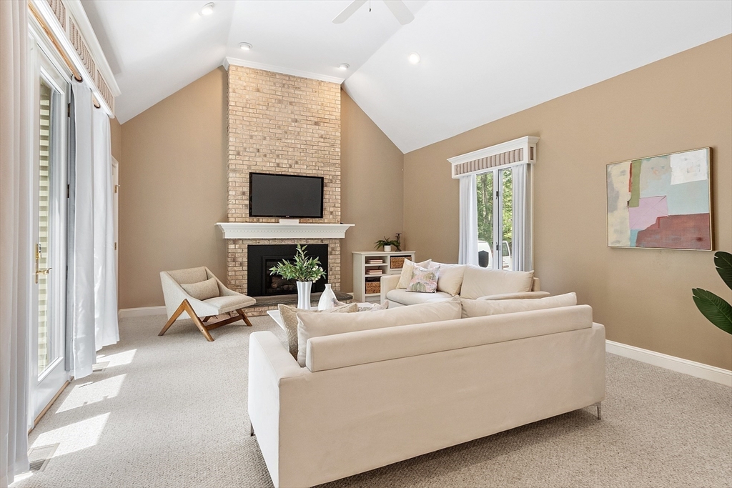151 Pope Road Acton, MA 01720 - Photo 18 of 34 a living room with furniture a fireplace and a flat screen tv
