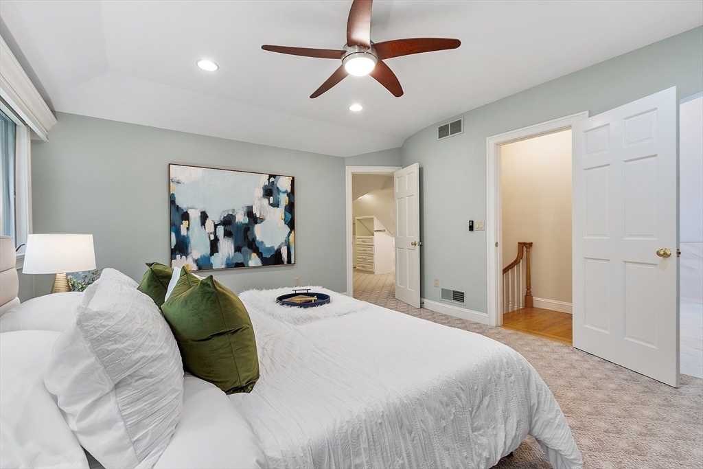 151 Pope Road Acton, MA 01720 - Photo 20 of 34 a bedroom with a bed and a chandelier