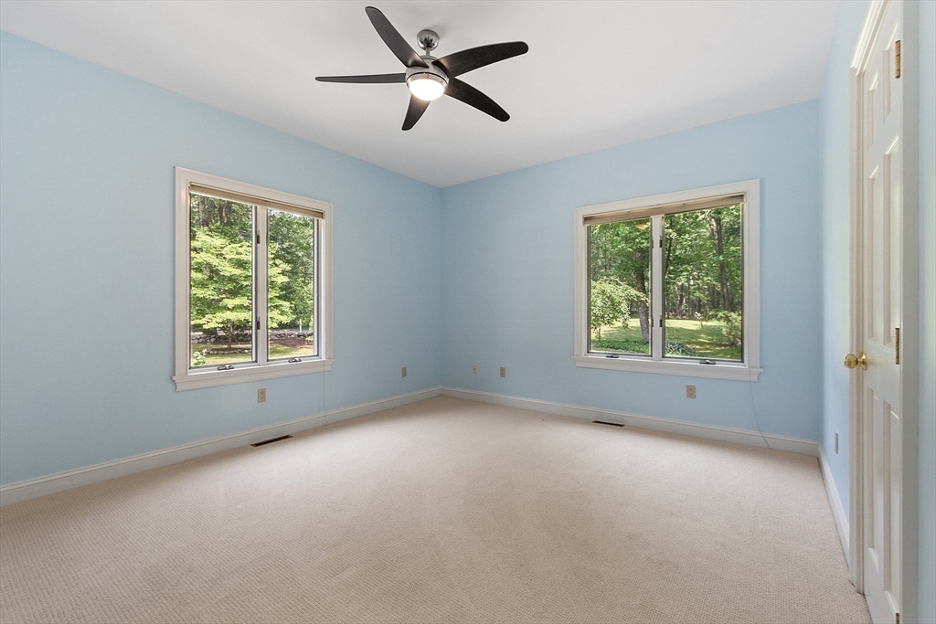 151 Pope Road Acton, MA 01720 - Photo 27 of 34 a view of a big room with windows and chandelier fan
