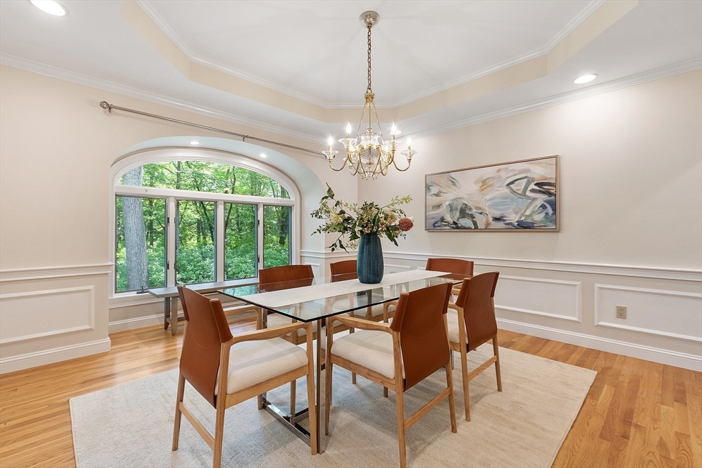 151 Pope Road Acton, MA 01720 - Photo 9 of 34 a view of a dining room with furniture a chandelier and wooden floor