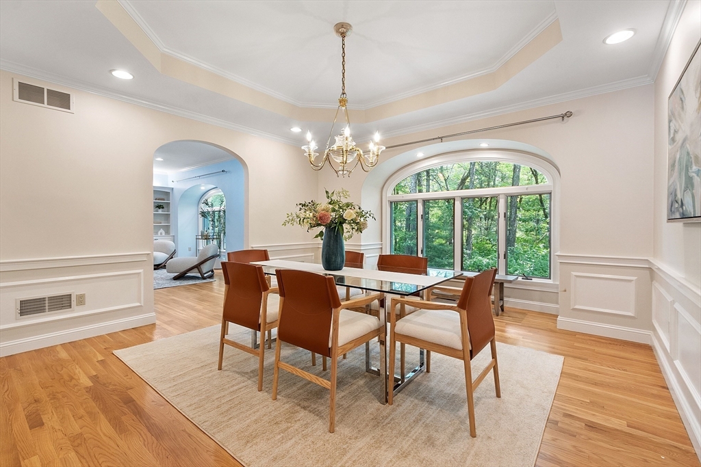 151 Pope Road Acton, MA 01720 - Photo 10 of 34 a dining room with furniture a chandelier and wooden floor