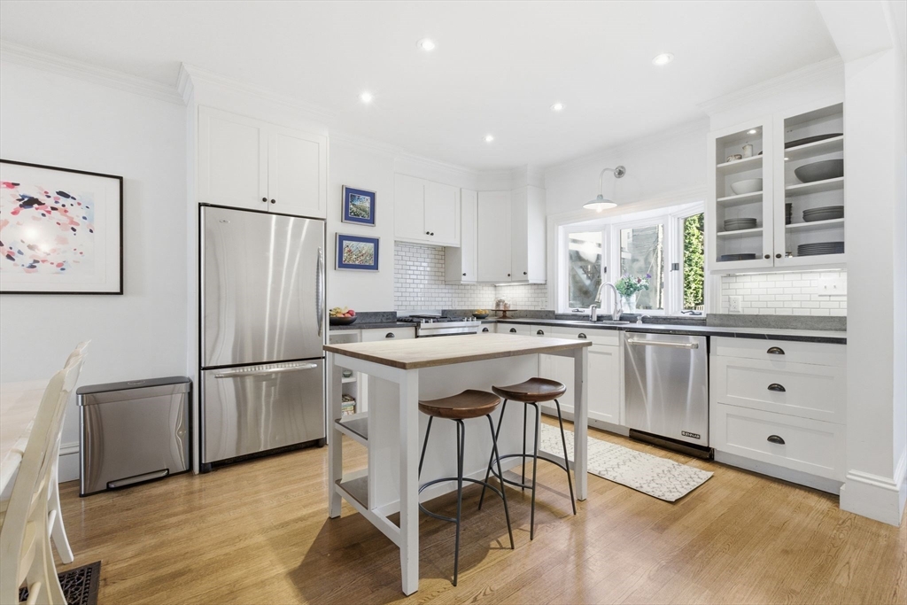 38 Bartlett Street Boston, MA 02129 - Photo 4 of 37 a kitchen with white cabinets and white stainless steel appliances