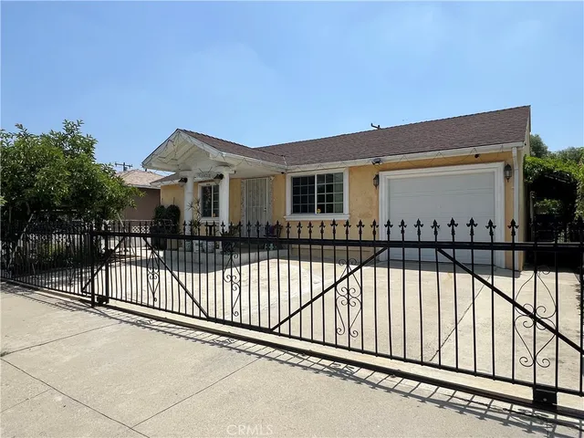 a view of a house with a wooden fence