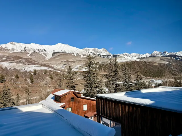 a view of a balcony with wooden fence and floor
