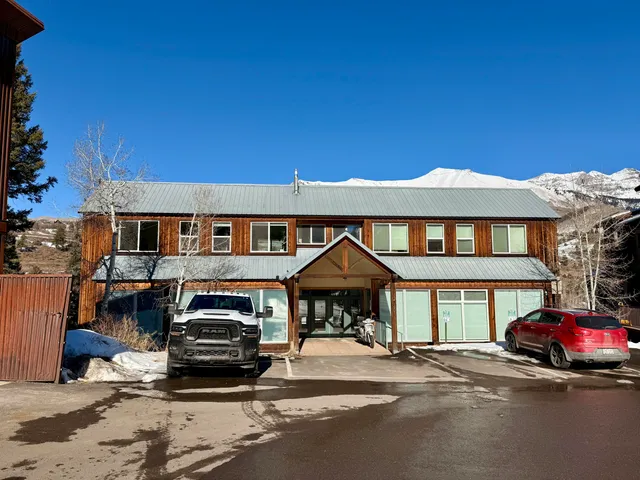 a view of a house with wooden deck front of house