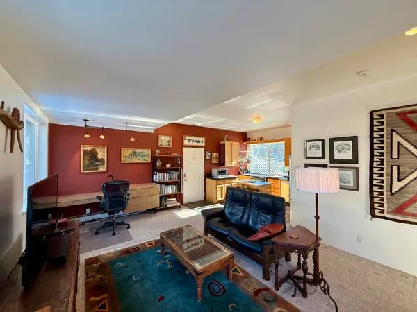 a living room with furniture and a piano