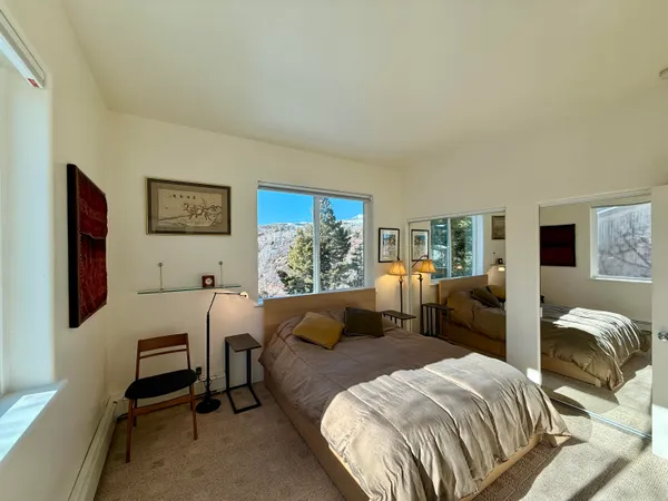 a bedroom with a bed and a couch