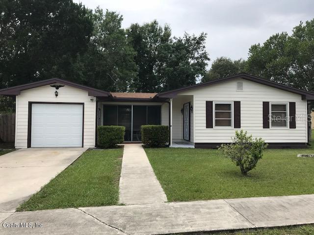3864 Southwest 143rd Ln Road Ocala, FL 34473 - Photo 1 of 1 a front view of a house with a garden