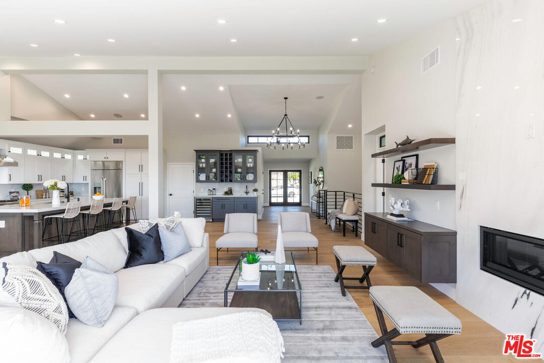 243 Notteargenta Road Pacific Palisades, CA 90272 - Photo 12 of 46 a living room with furniture and a flat screen tv