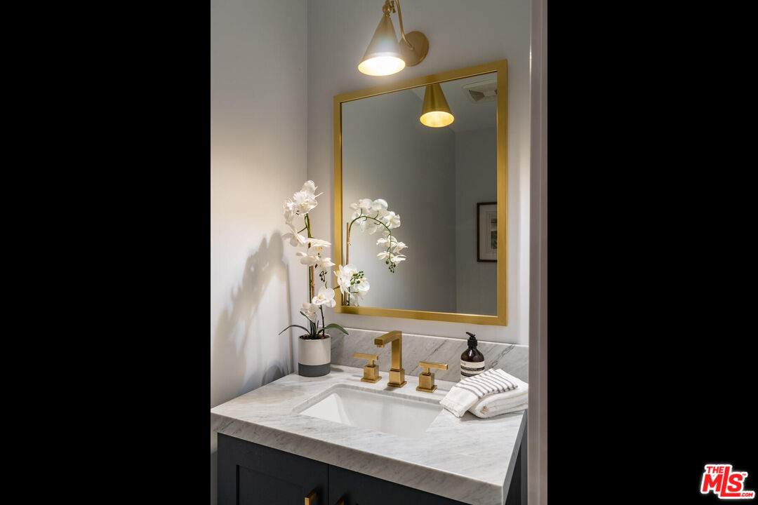 243 Notteargenta Road Pacific Palisades, CA 90272 - Photo 13 of 46 a en suite bathroom with a sink and a mirror