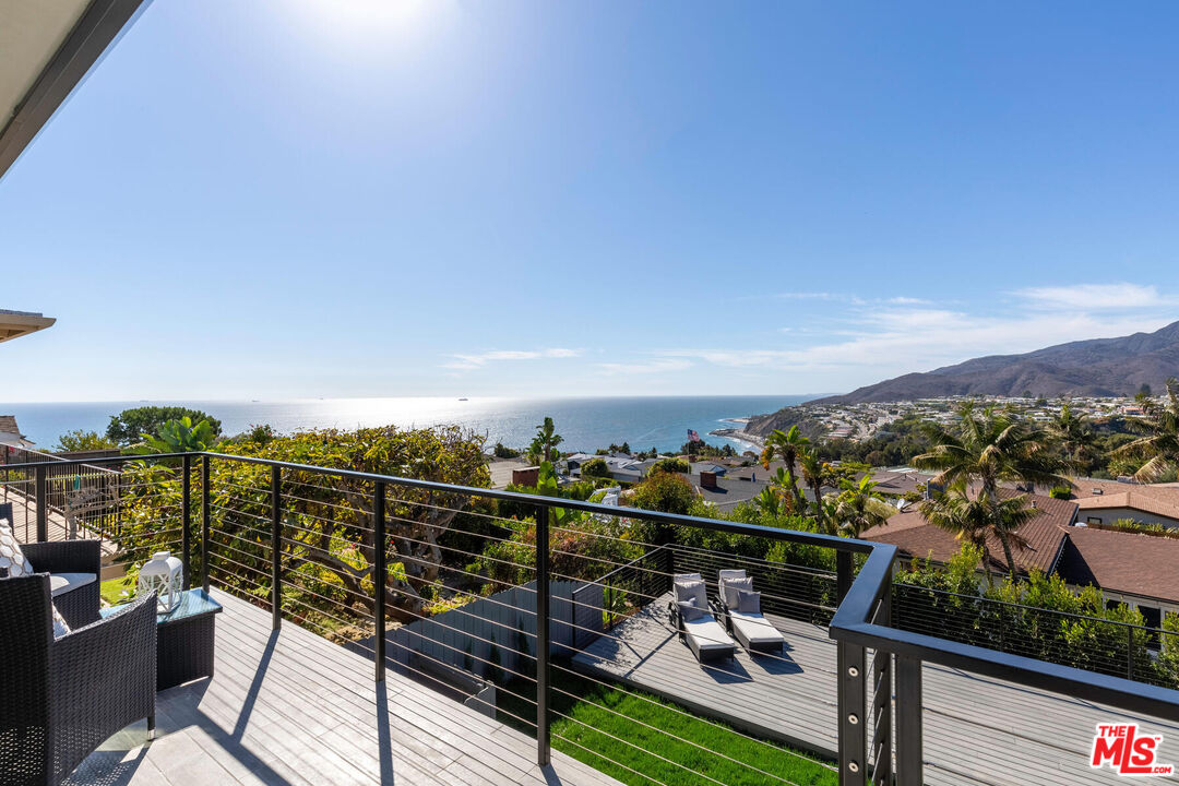243 Notteargenta Road Pacific Palisades, CA 90272 - Photo 17 of 46 a view of a balcony with two chairs and a potted plant