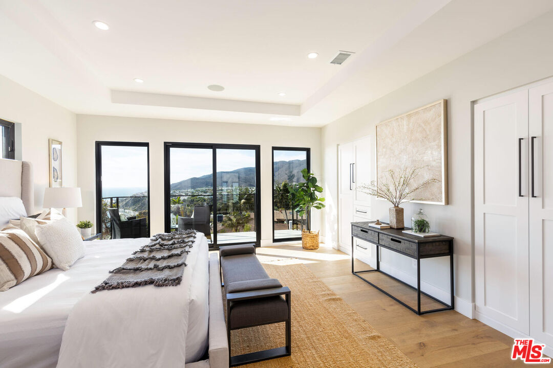 243 Notteargenta Road Pacific Palisades, CA 90272 - Photo 19 of 46 a living room with furniture and a large window