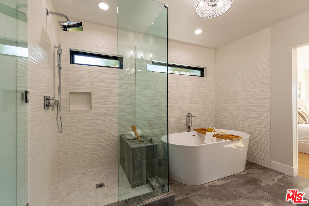 243 Notteargenta Road Pacific Palisades, CA 90272 - Photo 21 of 46 a bathroom with a bathtub and shower