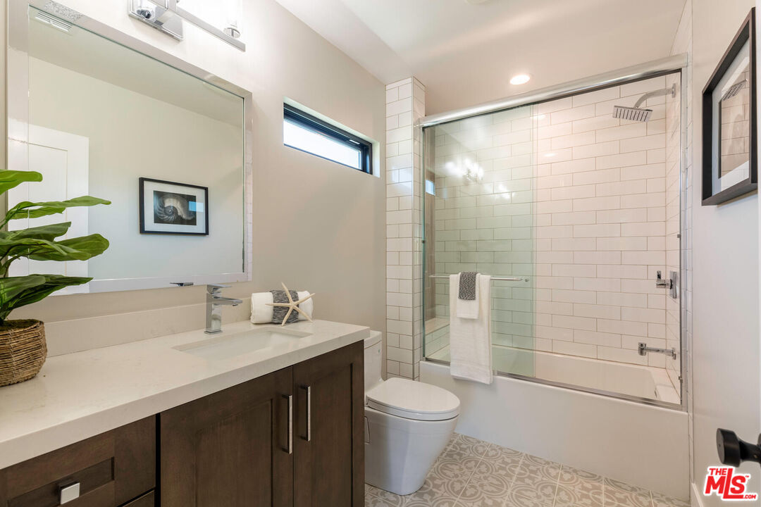 243 Notteargenta Road Pacific Palisades, CA 90272 - Photo 24 of 46 a bathroom with a sink a toilet and shower