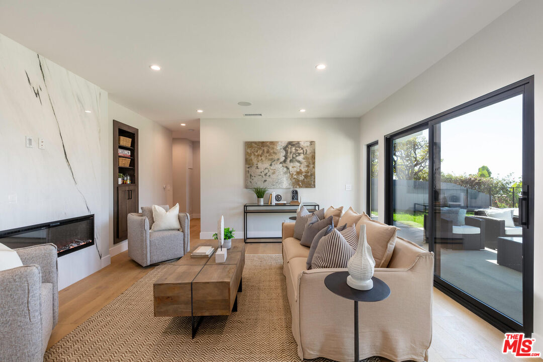 243 Notteargenta Road Pacific Palisades, CA 90272 - Photo 27 of 46 a living room with furniture and a large window