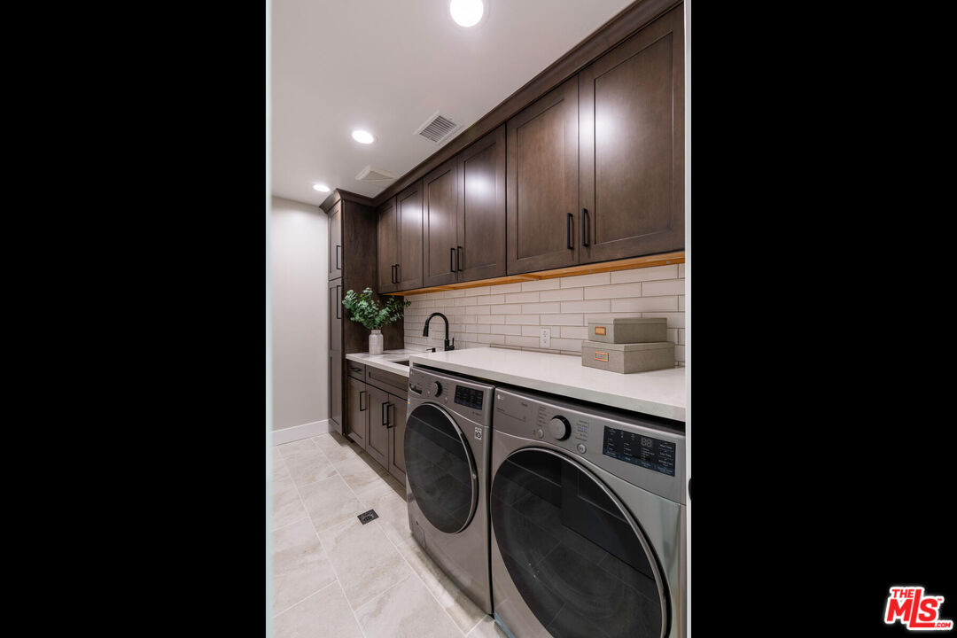 243 Notteargenta Road Pacific Palisades, CA 90272 - Photo 28 of 46 a view of a hallway with washer and dryer