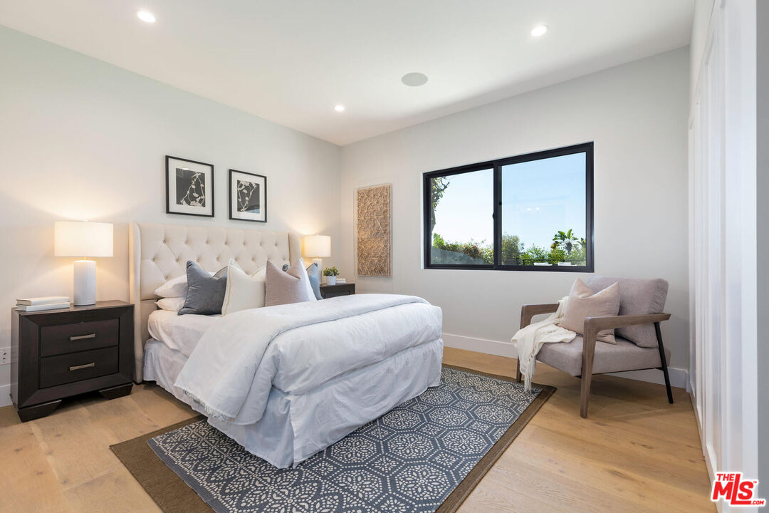 243 Notteargenta Road Pacific Palisades, CA 90272 - Photo 29 of 46 a bedroom with a bed and wooden floor