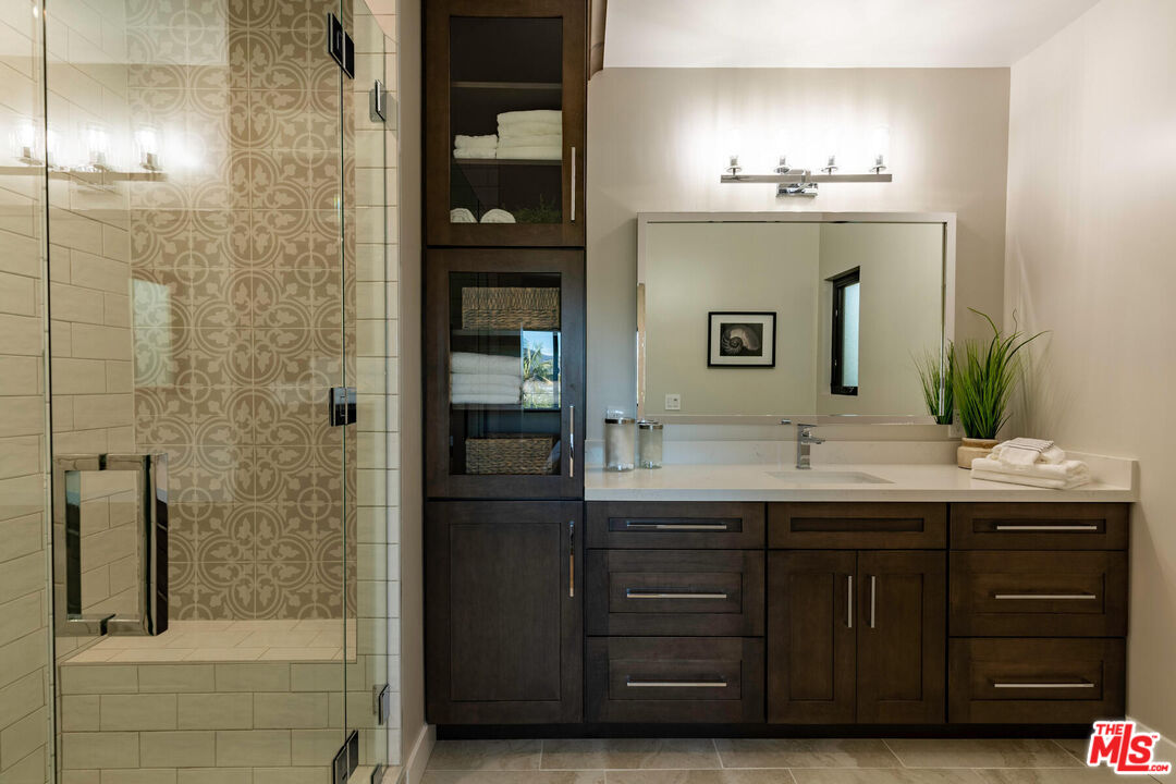 243 Notteargenta Road Pacific Palisades, CA 90272 - Photo 30 of 46 a bathroom with a sink and a mirror