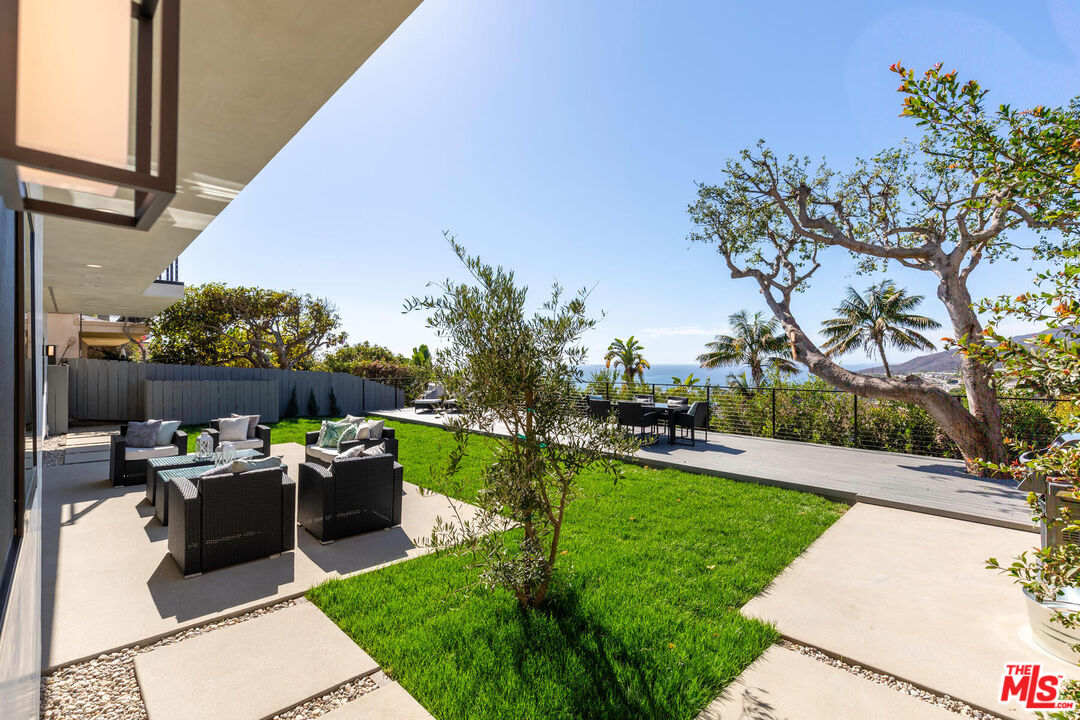 243 Notteargenta Road Pacific Palisades, CA 90272 - Photo 31 of 46 a view of a backyard with sitting area