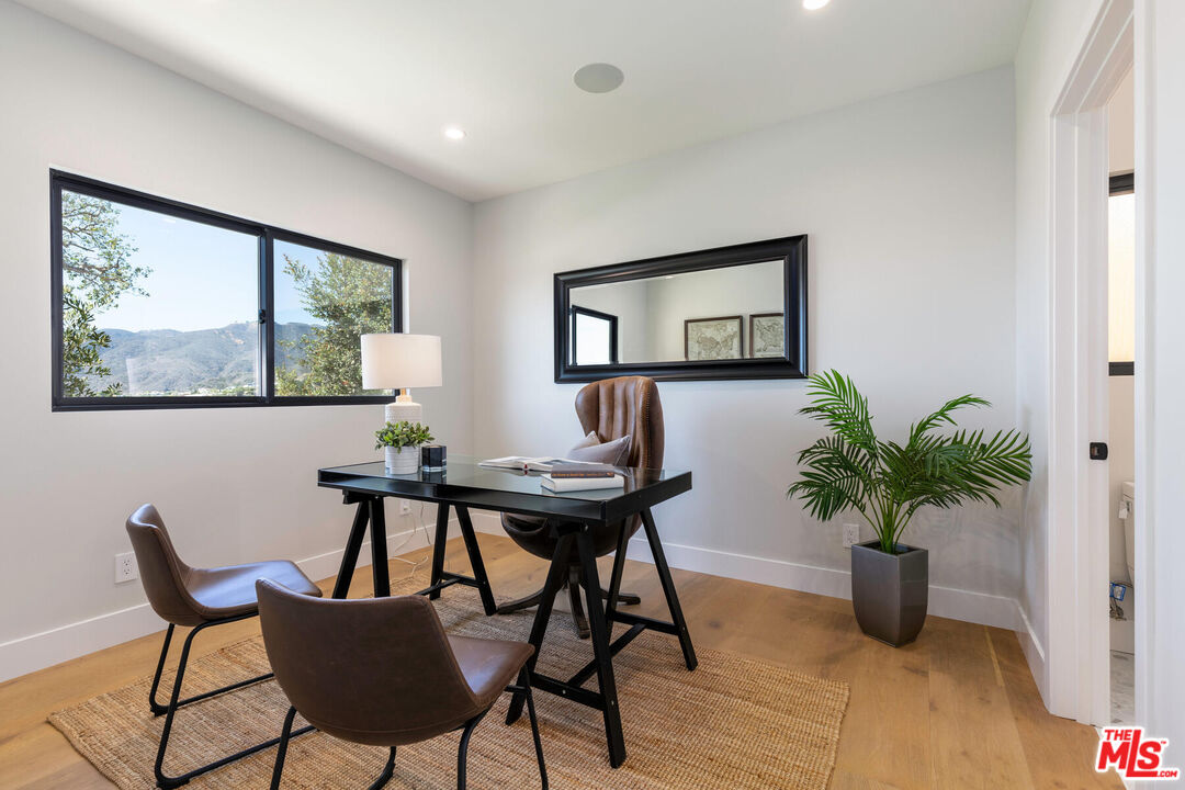 243 Notteargenta Road Pacific Palisades, CA 90272 - Photo 32 of 46 a view of a livingroom with furniture and a potted plant