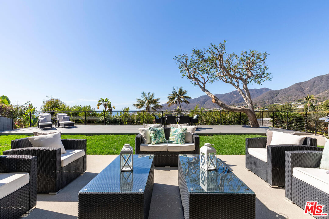 243 Notteargenta Road Pacific Palisades, CA 90272 - Photo 35 of 46 a view of a patio with couches table and chairs
