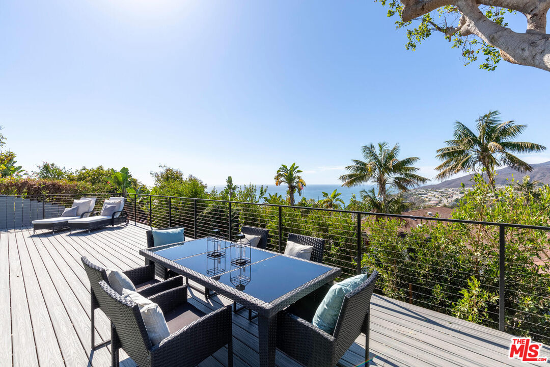 243 Notteargenta Road Pacific Palisades, CA 90272 - Photo 37 of 46 a view of a balcony with lake view and a potted plant