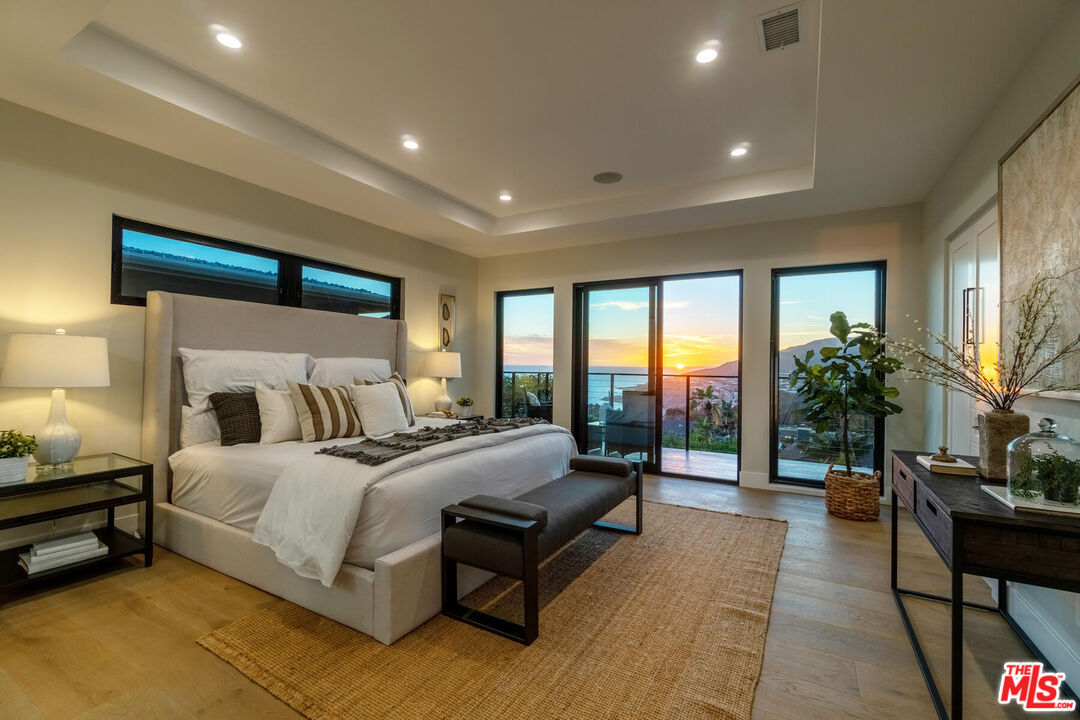 243 Notteargenta Road Pacific Palisades, CA 90272 - Photo 42 of 46 a bedroom with a bed couch and a large window
