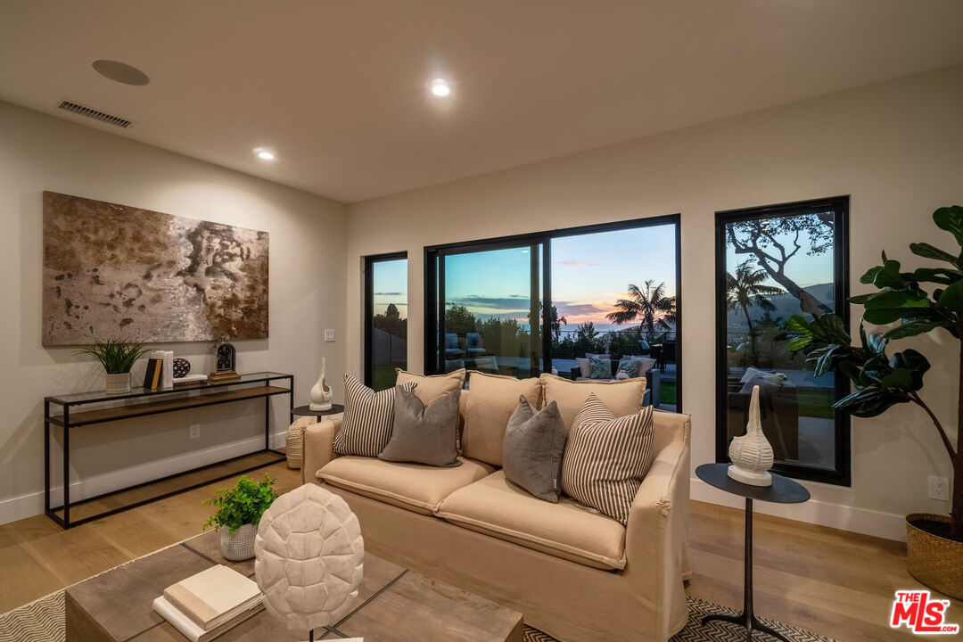 243 Notteargenta Road Pacific Palisades, CA 90272 - Photo 43 of 46 a living room with furniture and a flat screen tv