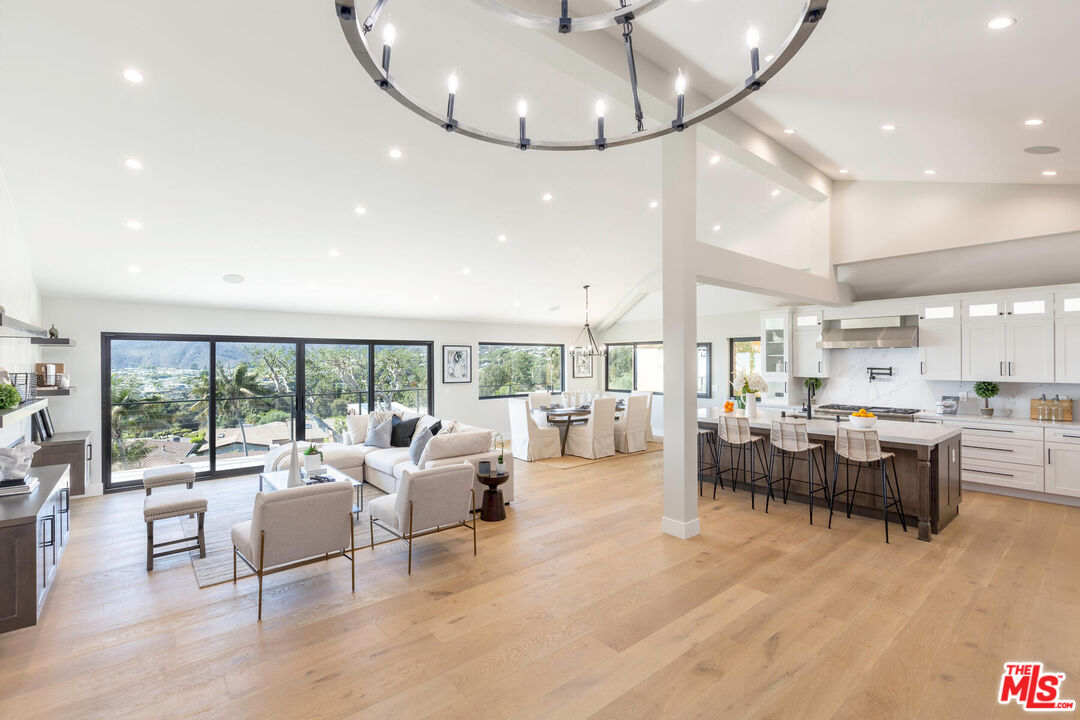 243 Notteargenta Road Pacific Palisades, CA 90272 - Photo 6 of 46 a living room with furniture and a large window