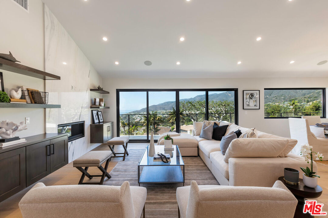243 Notteargenta Road Pacific Palisades, CA 90272 - Photo 10 of 46 a living room with furniture and a large window