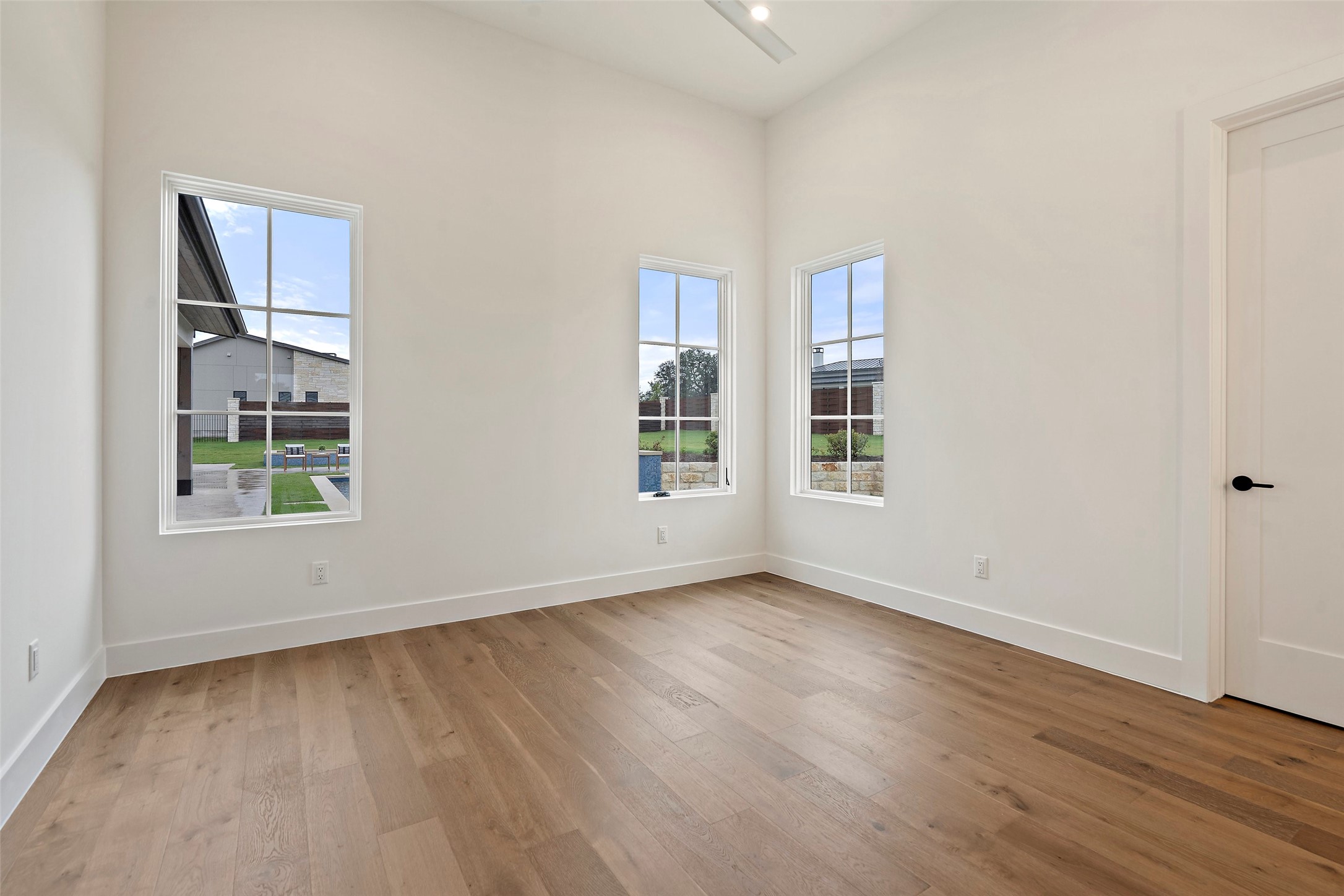 17212 Morning Grove Lane Austin, TX 78738 - Photo 25 of 38 a view of an empty room with wooden floor and a window
