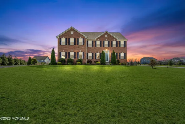 a view of a big house with a big yard
