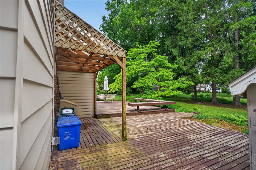 765 East Macada Road Bethlehem, PA 18017 - Photo 6 of 46 A spacious wooden deck with a charming pergola and built-in bench seating offers an ideal outdoor retreat.