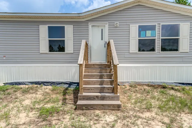 a view of wooden door and brick wall