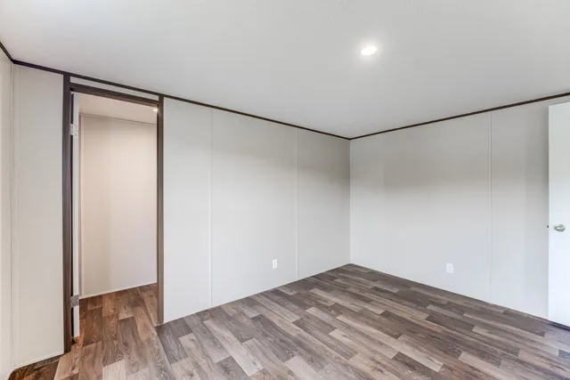 a view of a room with wooden floor